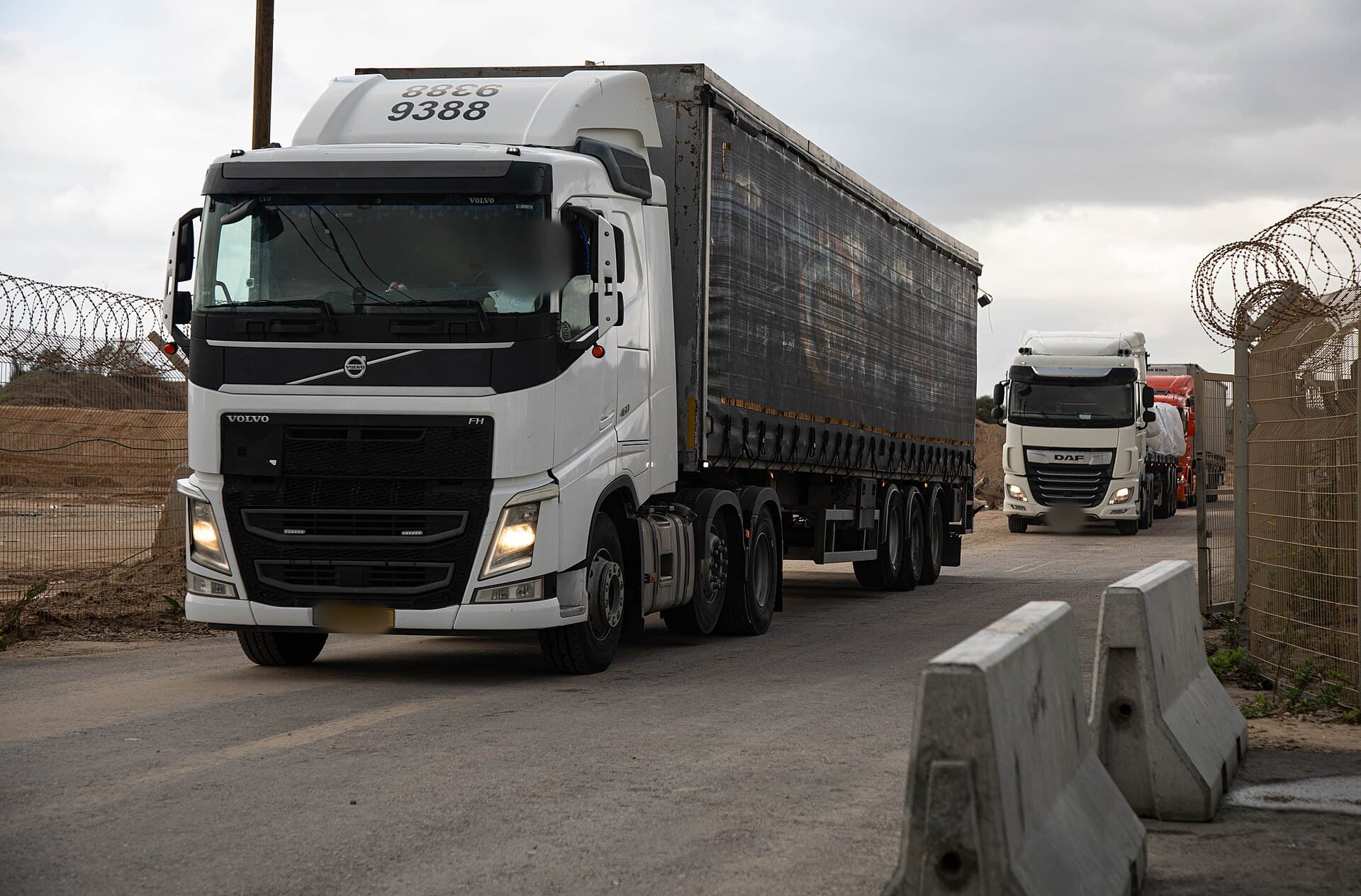 Trucks loaded with humanitarian aid queue at a crossing into Gaza
